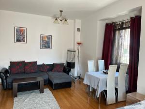 a living room with a couch and a table at Roman Gardens Studio Apartment in Risan