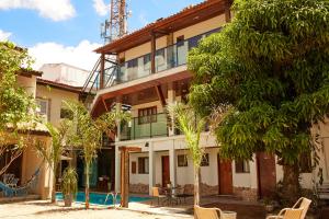 an exterior view of a house with trees at ROGAI Hotel&Pousada in Aparecida