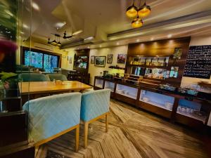 a restaurant with a table and chairs in a room at Hotel Middle Path & Spa in Pokhara