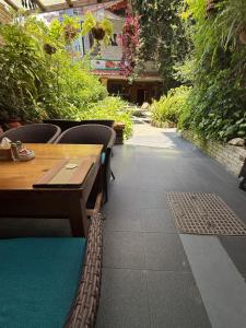 a patio with a wooden table and chairs at Hotel Middle Path & Spa in Pokhara
