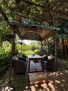 a patio with a table and chairs under a pergola at Hotel Middle Path & Spa in Pokhara
