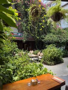 a garden with a wooden table and lots of plants at Hotel Middle Path & Spa in Pokhara