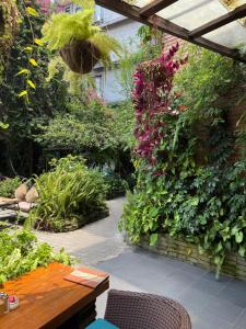 a patio with a table and some plants at Hotel Middle Path & Spa in Pokhara