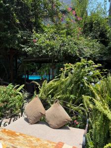two pillows sitting on a bench in a garden at Hotel Middle Path & Spa in Pokhara