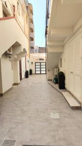 an empty hallway of an apartment building with a gate at Casa di Vicio in Marsala