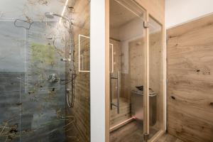 a bathroom with a shower with a glass door at Forchnerhof Nature & Mountain View Apartments in Terento +61 photos