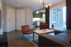 a living room with a couch and a table at Lägenhet i Klövsjö in Herräng