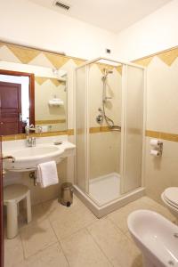 a bathroom with a shower and a sink at Mariano IV Palace Hotel in Oristano