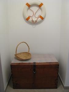 a basket and a towel on a wall with a chest at Apartment Sea Garden in Ičići