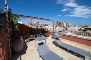 a patio with chairs and tables on a roof at Vista Mare 16 in Siracusa