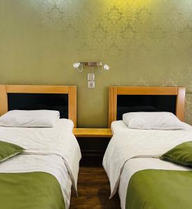 Postel nebo postele na pokoji v ubytování Hotel Kiwi Garden