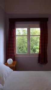 a bedroom with a bed and a window at Philoxenia in Spata