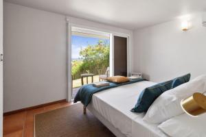 a bedroom with a bed and a large window at Villa Maravistah in Saint-François +19 photos