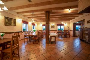 a dining room with wooden tables and chairs at Green Escape garni hotel in Postojna
