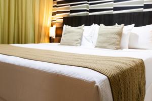 Postel nebo postele na pokoji v ubytování Mais Hotel Aeroporto Salvador