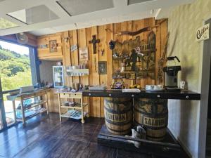 a room with wooden walls and a bar with a counter at Logis Hôtel Restaurant L'Escapade in Le Crestet