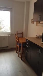a kitchen with a wooden table and a window at Wohnung am Hauptmarkt! in Nuremberg