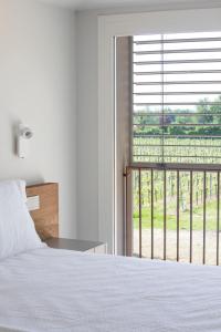 a bedroom with a bed and a window with a view at Ca' Allegra in Mogliano Veneto