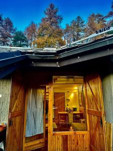 a house with a wooden door and a table at Il nido di pila in Pila