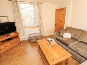 a living room with a couch and a coffee table at Sun House in Maryport