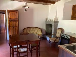 a living room with a table and a fireplace at Torre Cavina in Palazzuolo sul Senio