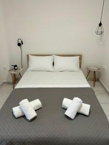 a bed with three pillows on top of it at SK Apartment II in Perea