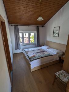 a bedroom with a bed and two windows at Apartmani Lili in Crikvenica