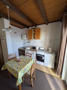 a small kitchen with a table and a stove at Apartmani Lili in Crikvenica +32 photos