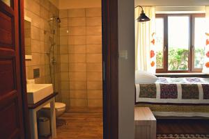 a bathroom with a sink and a toilet and a window at Ostoja Wigierski in Mikolajewo +100 photos