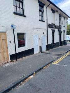 an empty street in front of a white building at Talbot Guest House in Birmingham