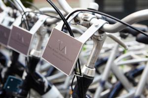 
a row of bicycle racks with bicycles attached to them at The Muse Amsterdam - Boutique Hotel in Amsterdam
