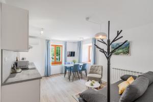 a living room and kitchen with a couch and a table at Apartments Wojcicky in Bovec