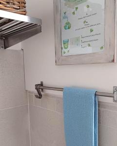 a towel rack in a bathroom with a blue towel at Le Jardin Secret in Milan +41 photos