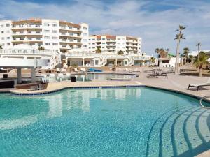 a large swimming pool in front of some buildings at Beachfront Las Palmas D502 in Puerto Peñasco