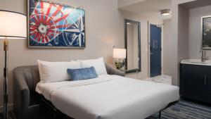 a bedroom with a large bed and a sink at JW Marriott Savannah Plant Riverside District in Savannah