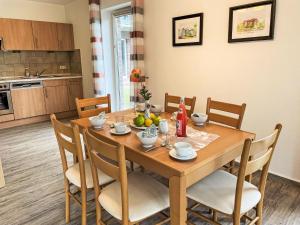 a dining room with a wooden table and chairs at Holiday Home Müritz Ferienpark Röbel-62 by Interhome in Röbel