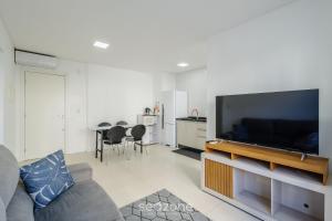 a living room with a large flat screen tv at Apt c/ Churrasq. a 600m da Praia GEN0102 in Balneário Camboriú