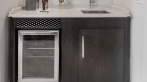 a kitchen with a sink and a cabinet with a door at JW Marriott Savannah Plant Riverside District in Savannah