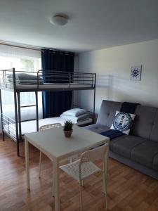 a living room with a couch and a bunk bed at Wypoczynkowo in Stegna