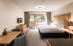 Postel nebo postele na pokoji v ubytování Das Kaltenbach - ApartHotel