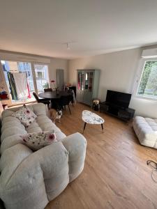 a living room with a couch and a table at Appartement Saint Cyr sur Loire in Saint-Cyr-sur-Loire