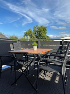 a wooden table and chairs on a balcony at ZwoLu Apartments in Bornheim +29 photos