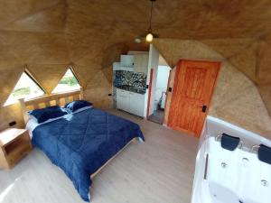 a bedroom with a bed in a large room at San Jerónimo Glamping in Tota