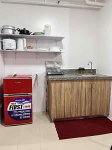 a kitchen with a counter and a sink in a room at Urban Deca Staycation in Manila by April & Ivan in Manila