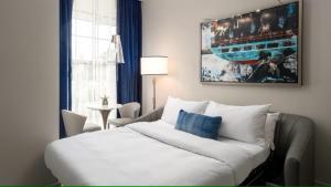 a living room with a white couch in front of a window at JW Marriott Savannah Plant Riverside District in Savannah