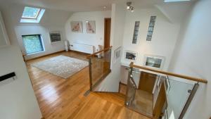 an open hallway with a staircase with a glass railing at The Curlew in Carrigart