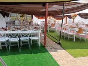 a group of tables and chairs under a tent at Twilight Breeze Lodge in Phuthaditjhaba