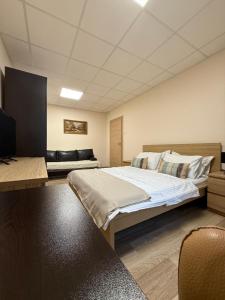 a bedroom with a large bed and a couch at Home Sweet Home - Apartament central 2 camere in Craiova +6 photos