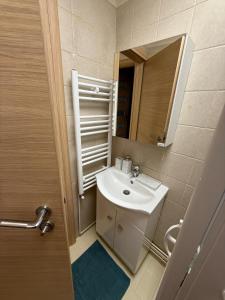 a bathroom with a sink and a mirror at Home Sweet Home - Apartament central 2 camere in Craiova