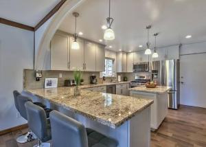 a large kitchen with a large island with chairs at 2148 Inverness Drive home in South Lake Tahoe
